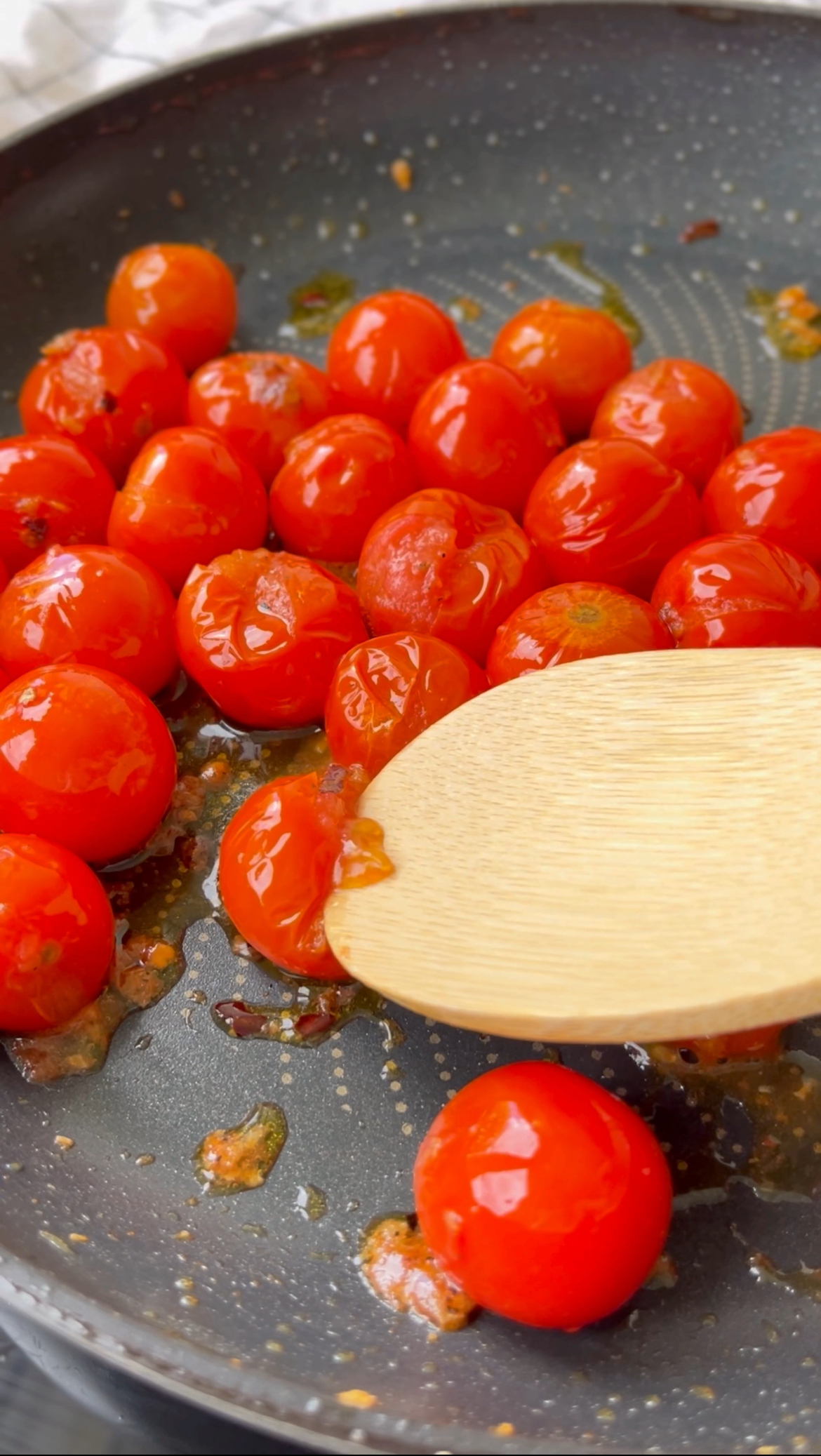 squashing tomatoes in the pan