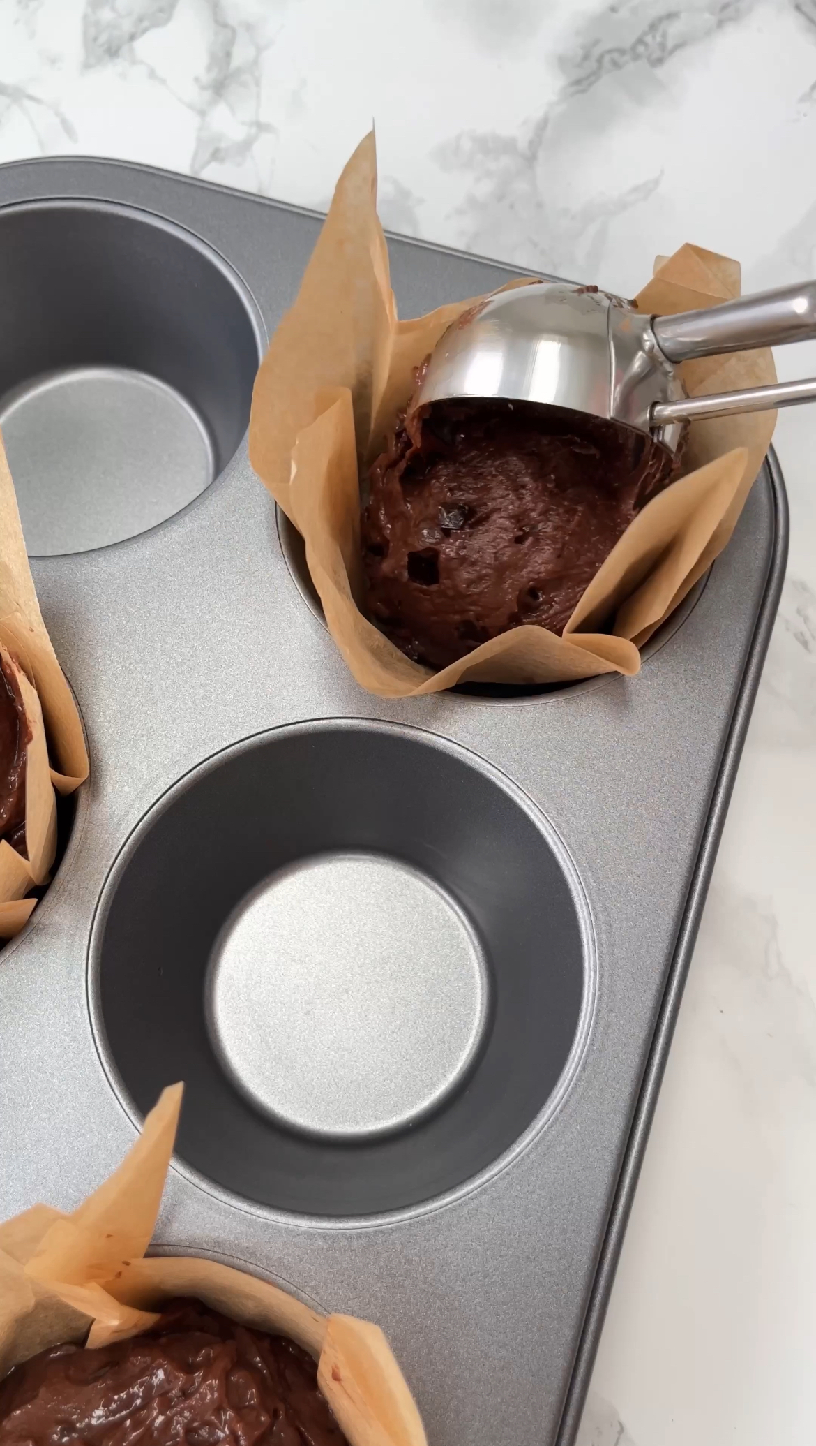 SCOOPING INTO MUFFIN TIN