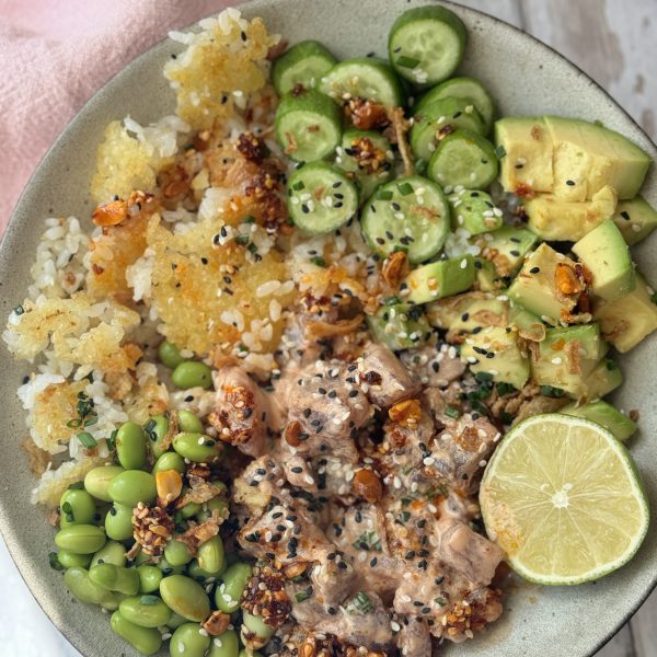 spicy tuna in a bowl with crispy rice and cucumber and avocado