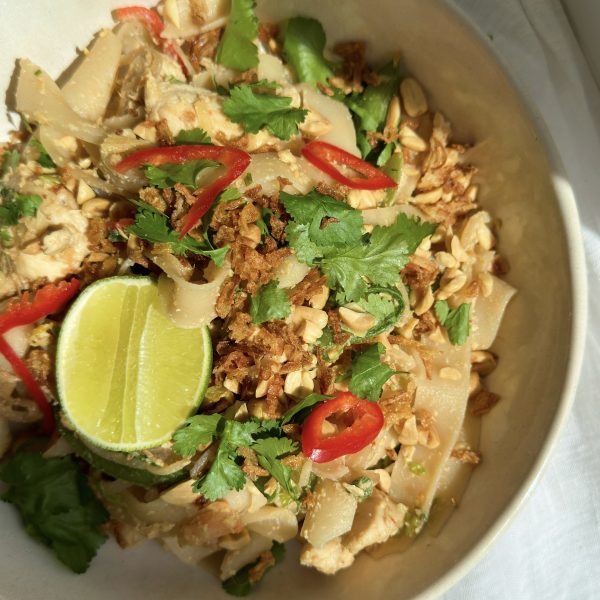 wagamama pad thai in a bowl with half a lime