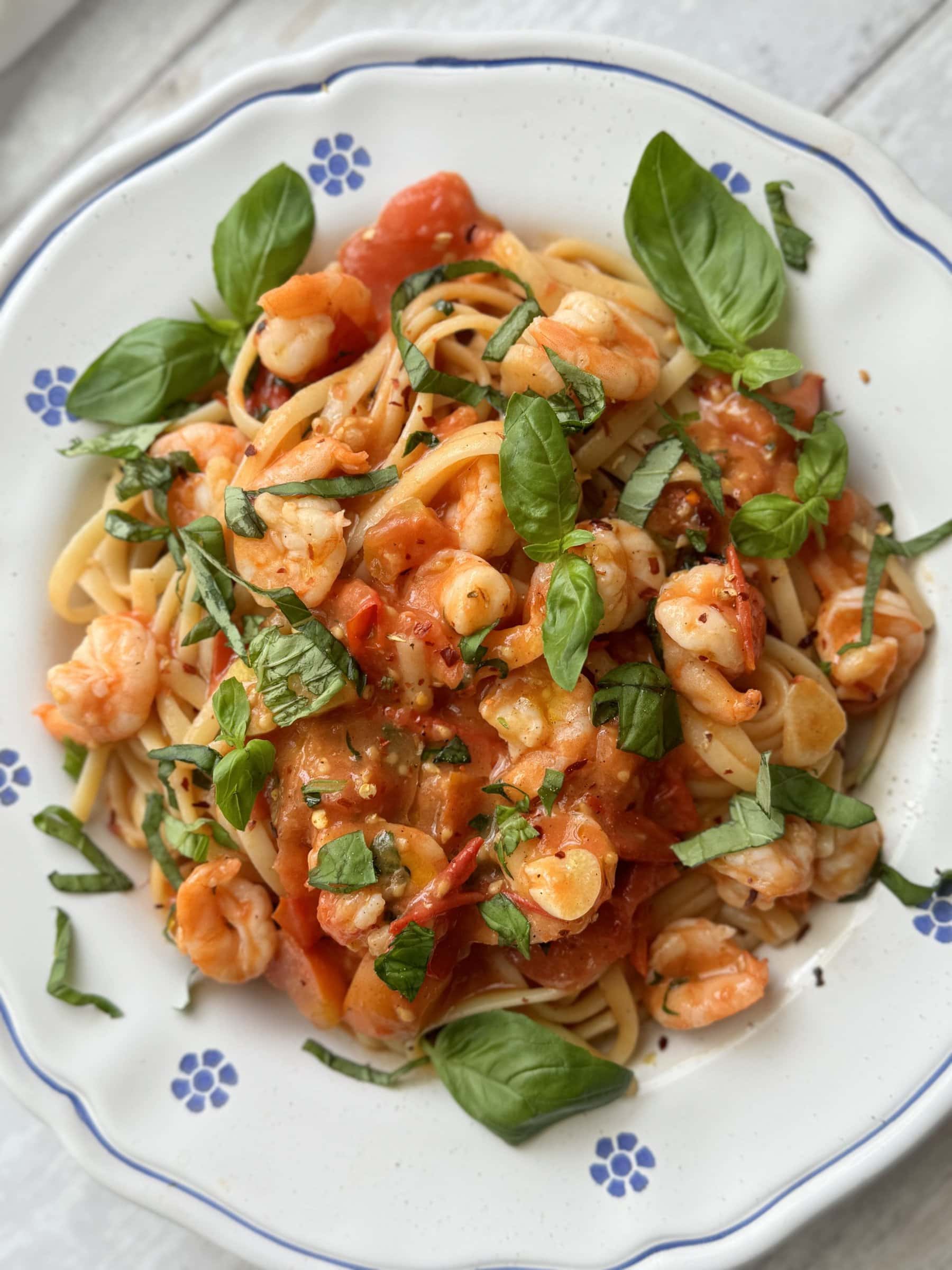 a plate of prawn tomato linguine