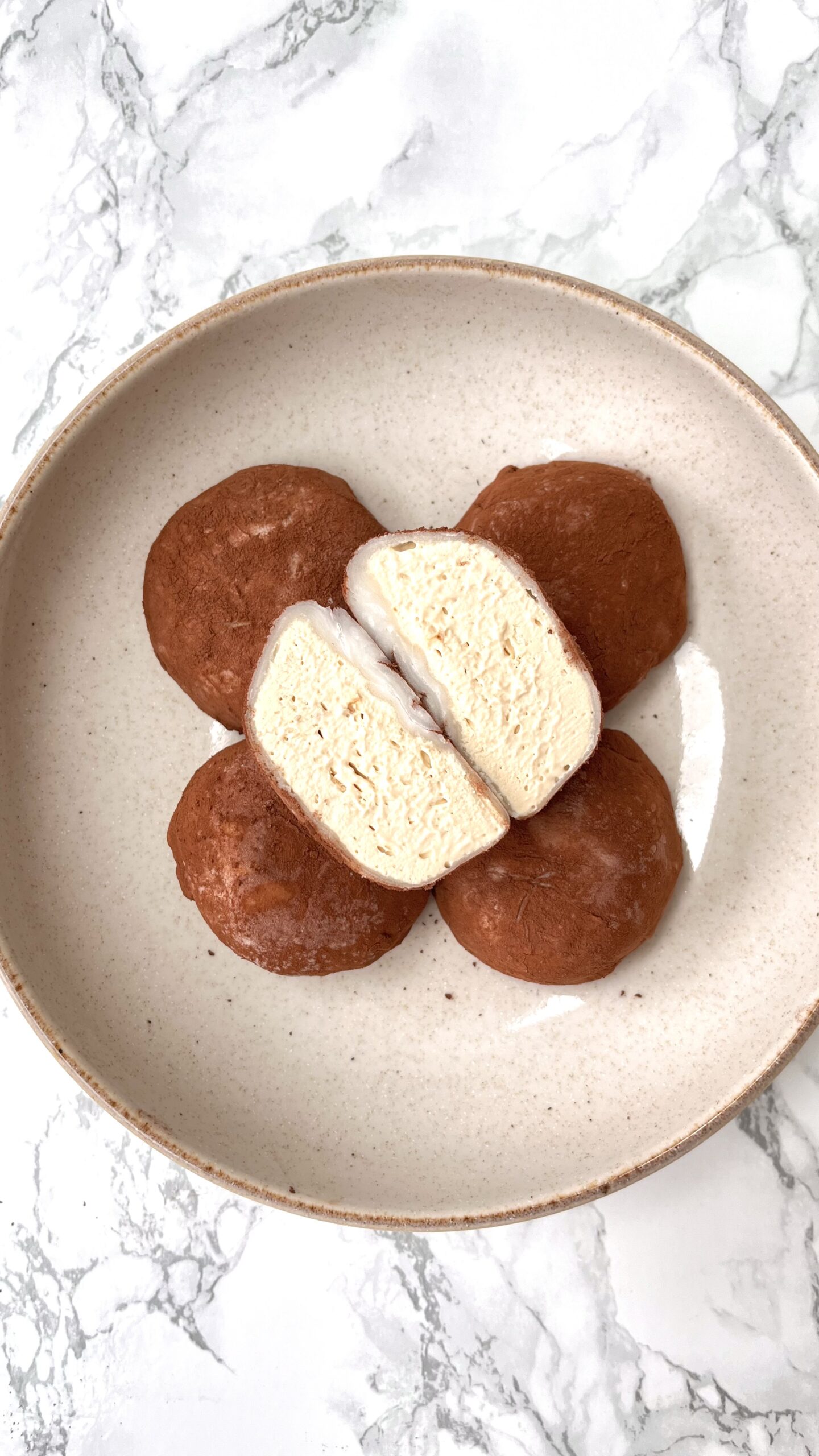 coffee and chocolate mochi in a bowl, one cut in half