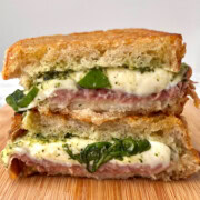 Stanley Tucci sandwich cut in half on board.