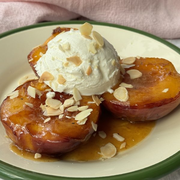 peaches and cream on a white plate with green trim