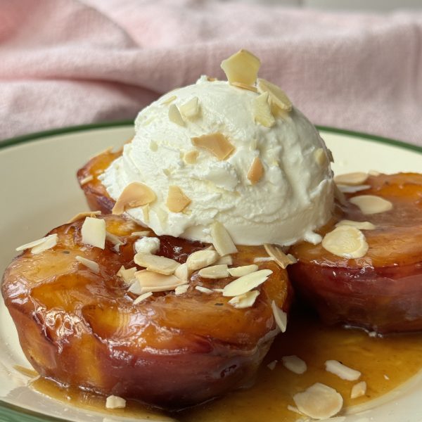 peaches and cream on a white plate with green trim