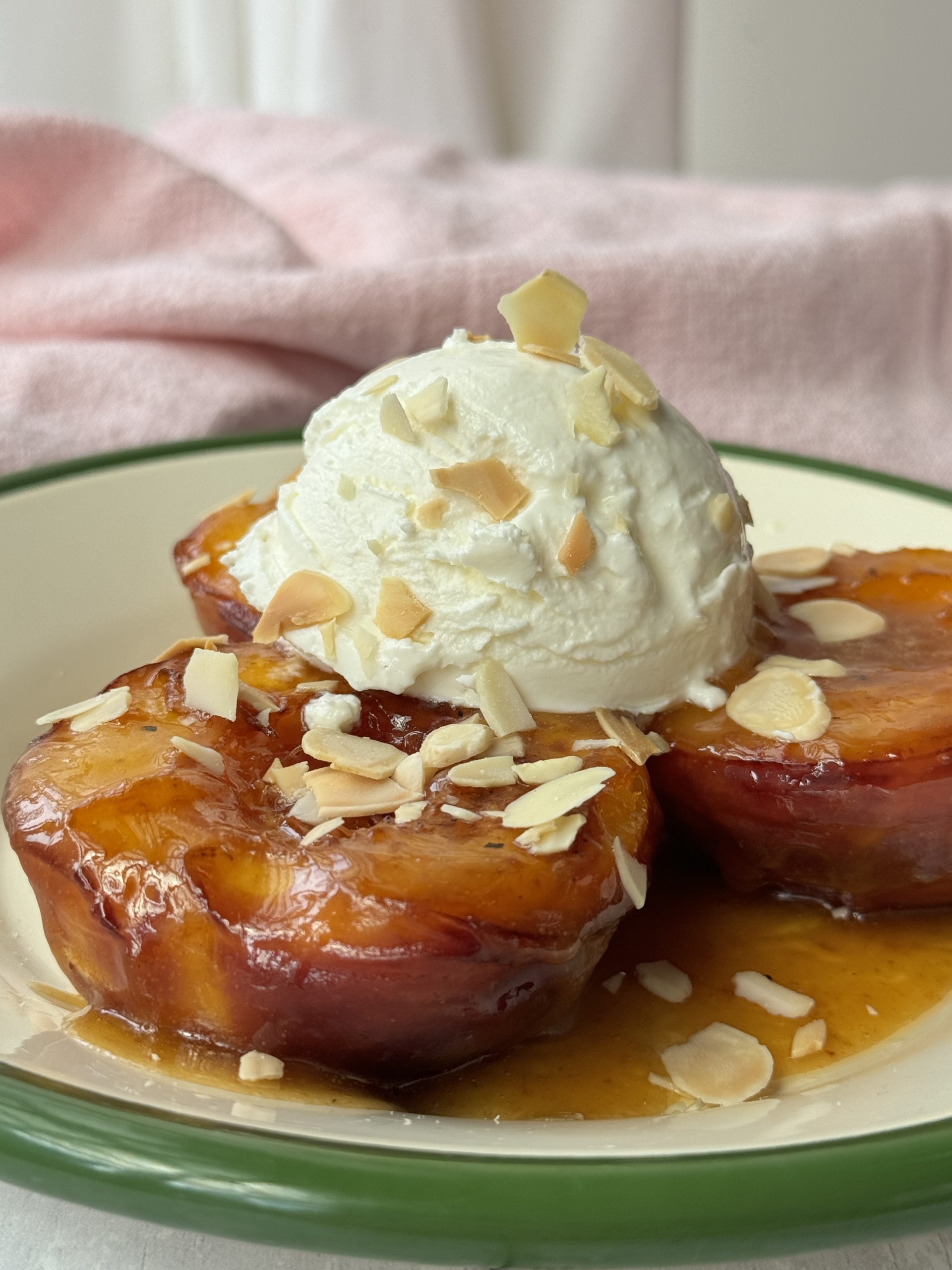 peaches and cream on a white plate with green trim