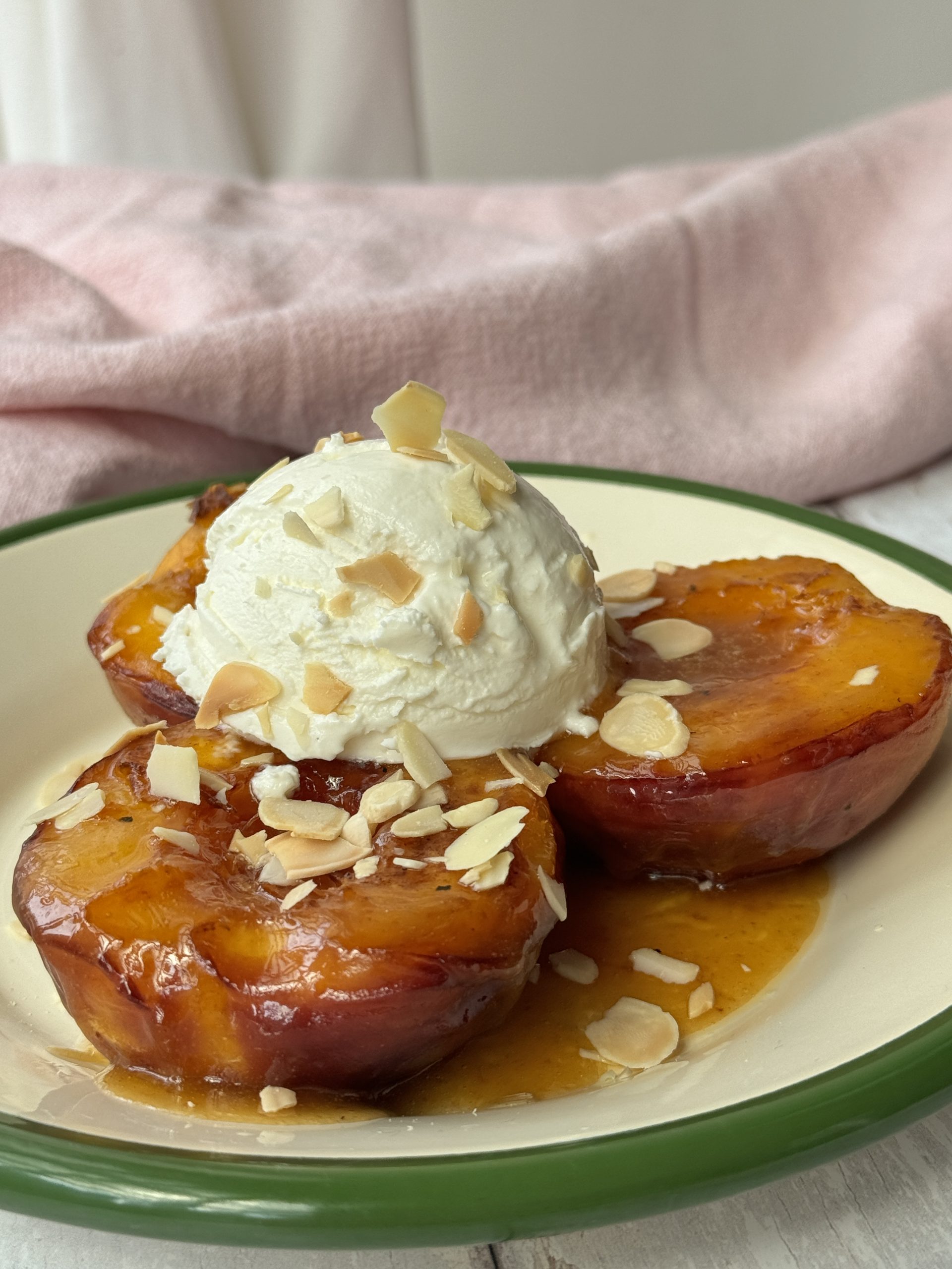 peaches and cream on a white plate with green trim