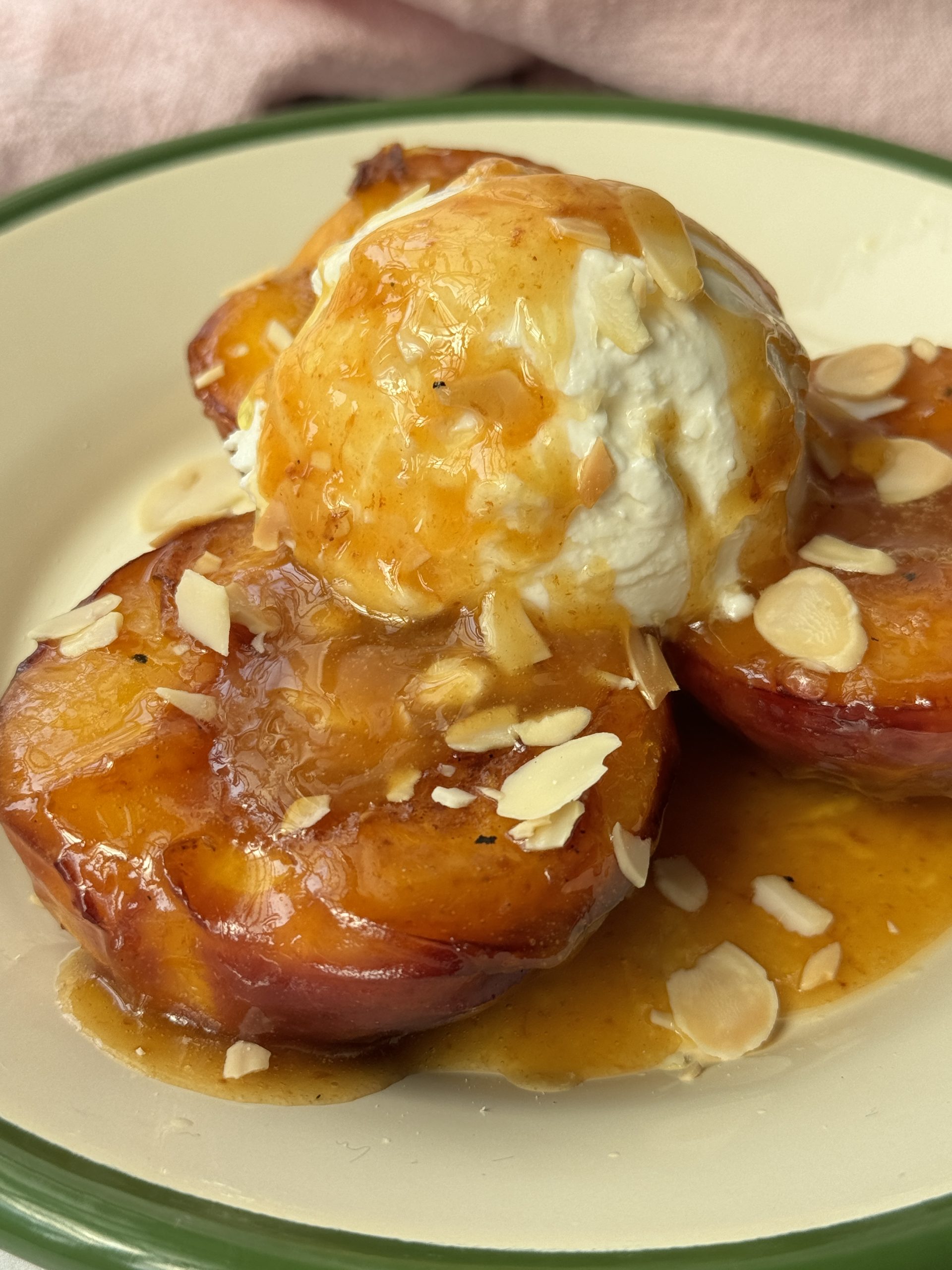 peaches and cream on a white plate with green trim