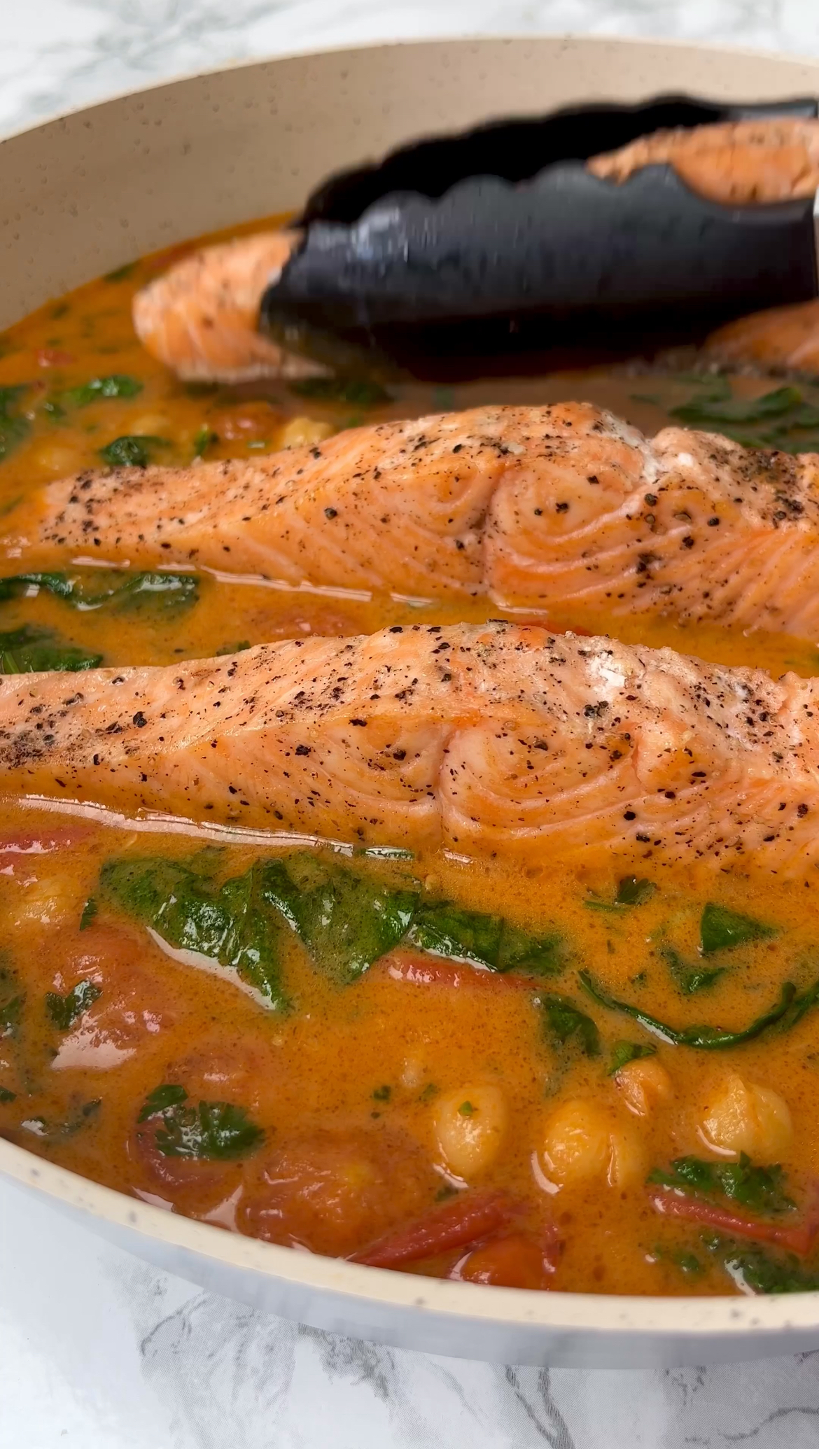 adding salmon to the curry