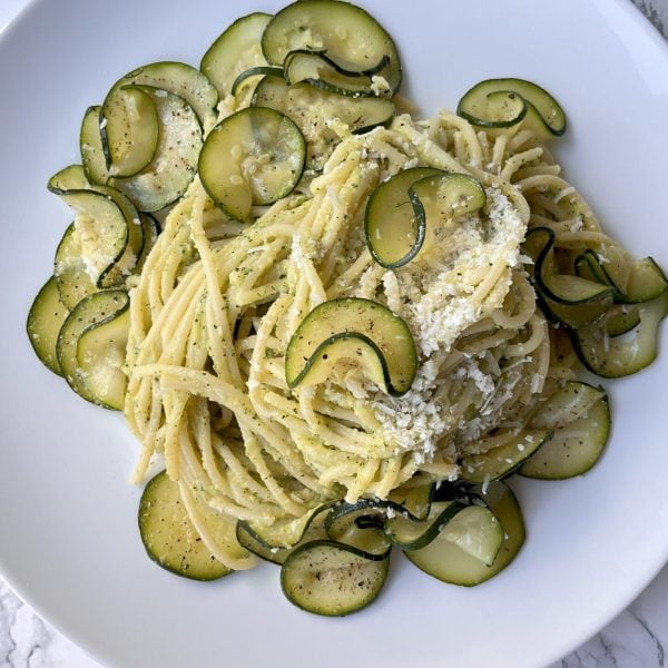 spaghetti alla nerano on a white plate