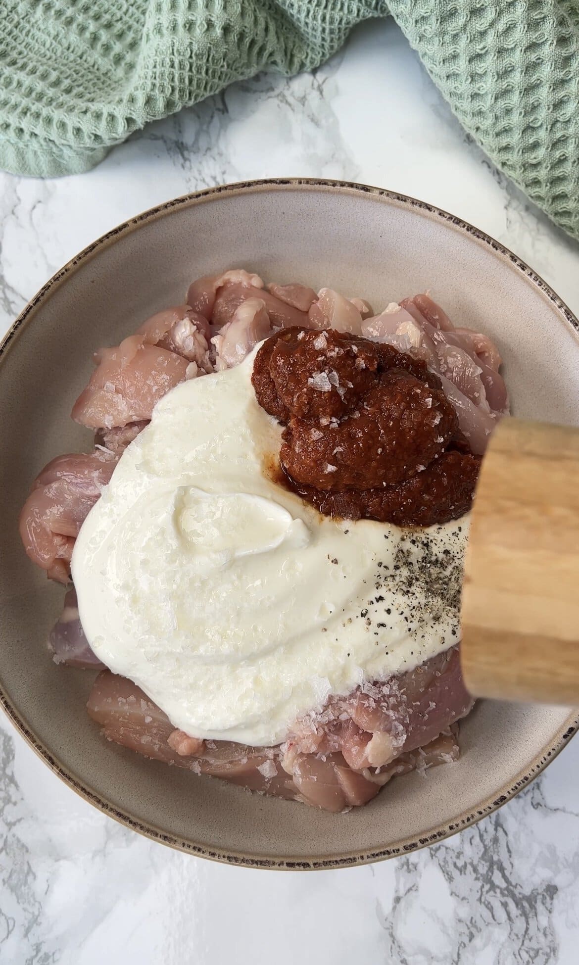 marinating chicken with yoghurt and harissa.