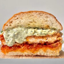 chicken parm sandwich cross section on a marble counter