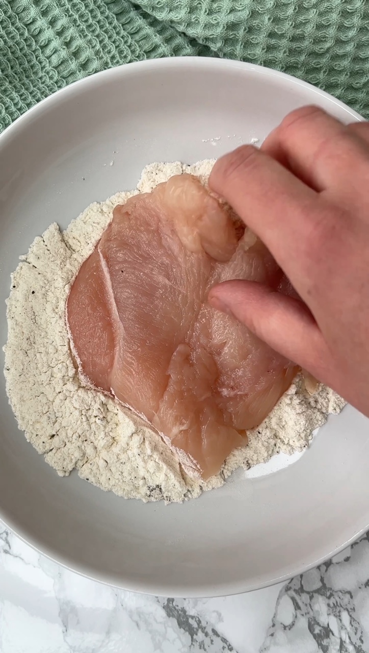 flouring the chicken breast