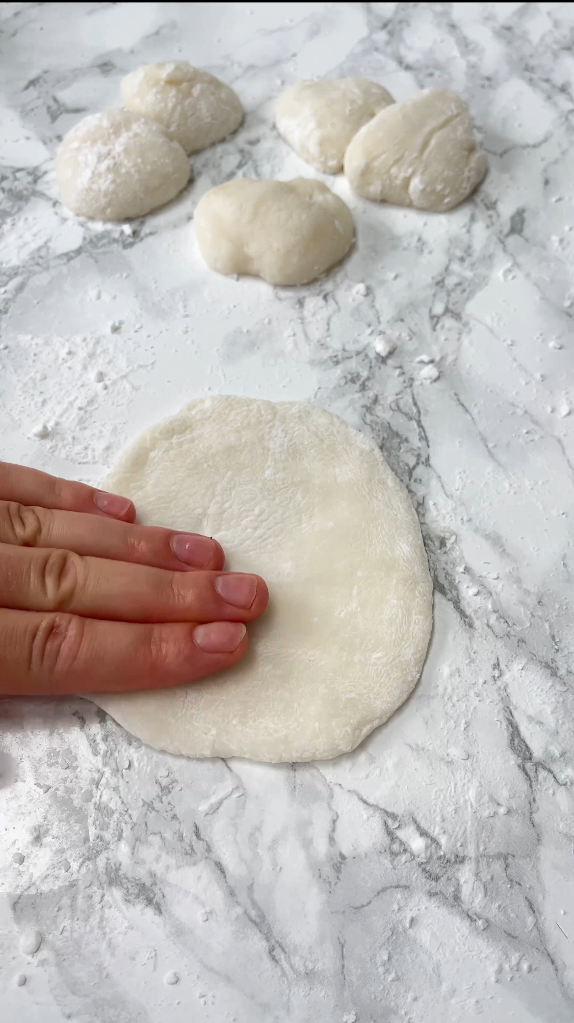 patting out mochi dough