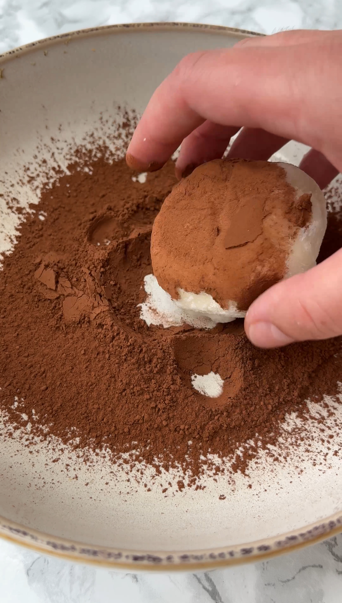 rolling mochi in chocolate