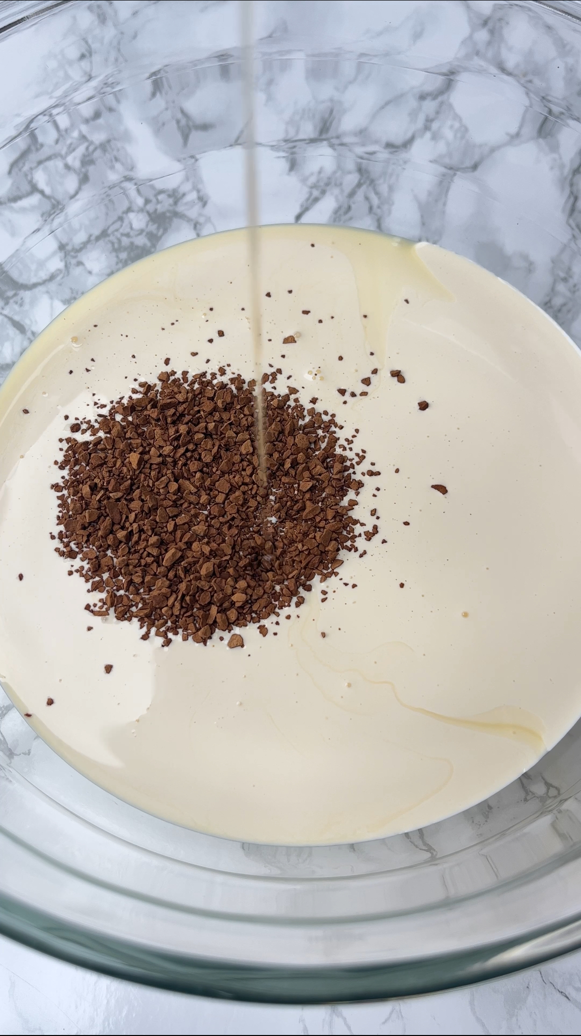 adding coffee to the cream and condensed milk