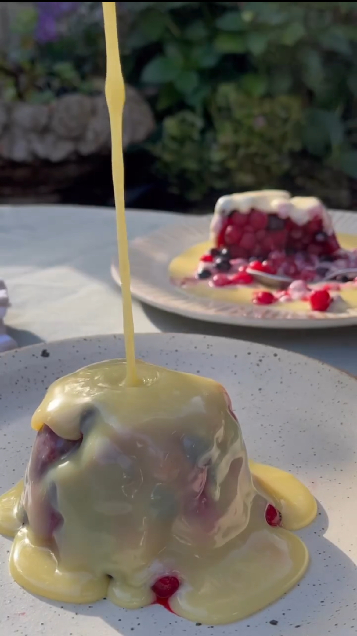 pouring white chocolate on frozen berries