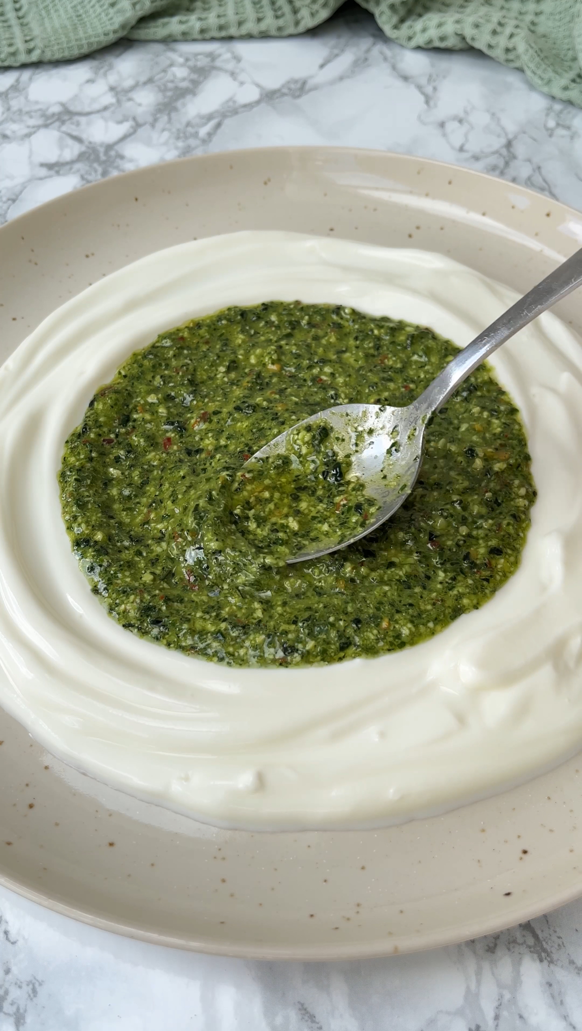 smoothing chimichurri on the yoghurt