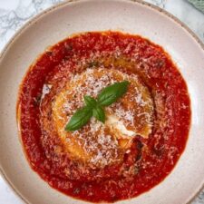 mozzarella in carrozza on tomato sauce on a beige plate.