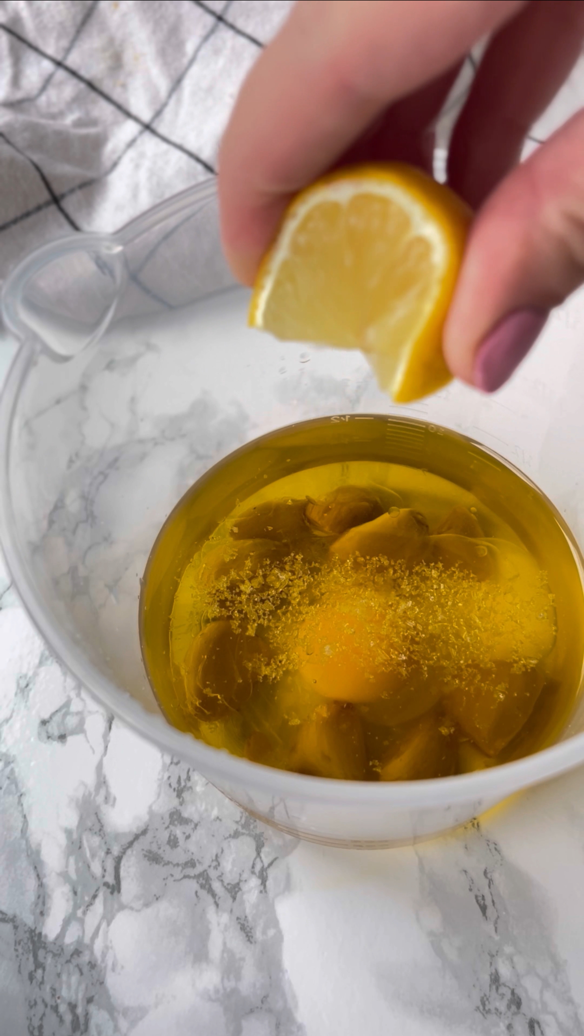 adding lemon to make roasted garlic aioli