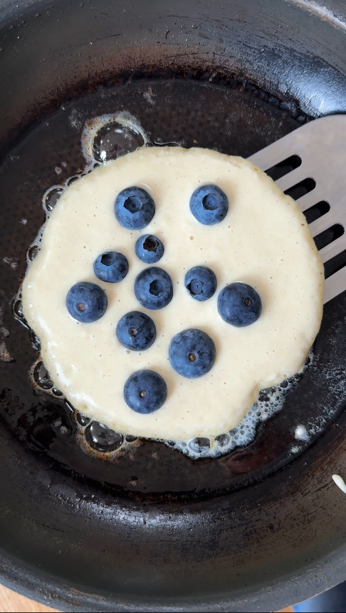 adding blueberries to easy pancakes