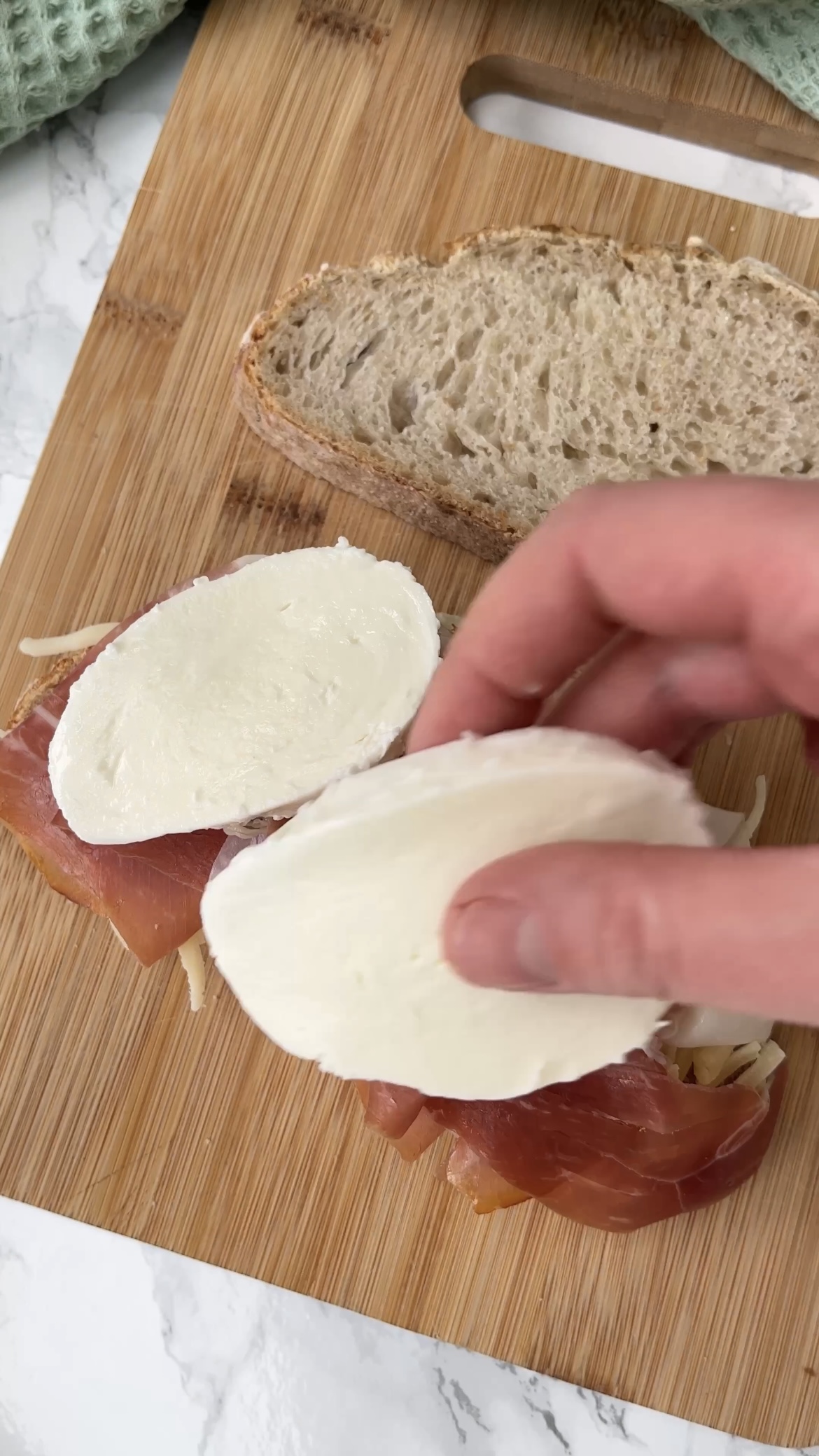 laying ingredients on bread