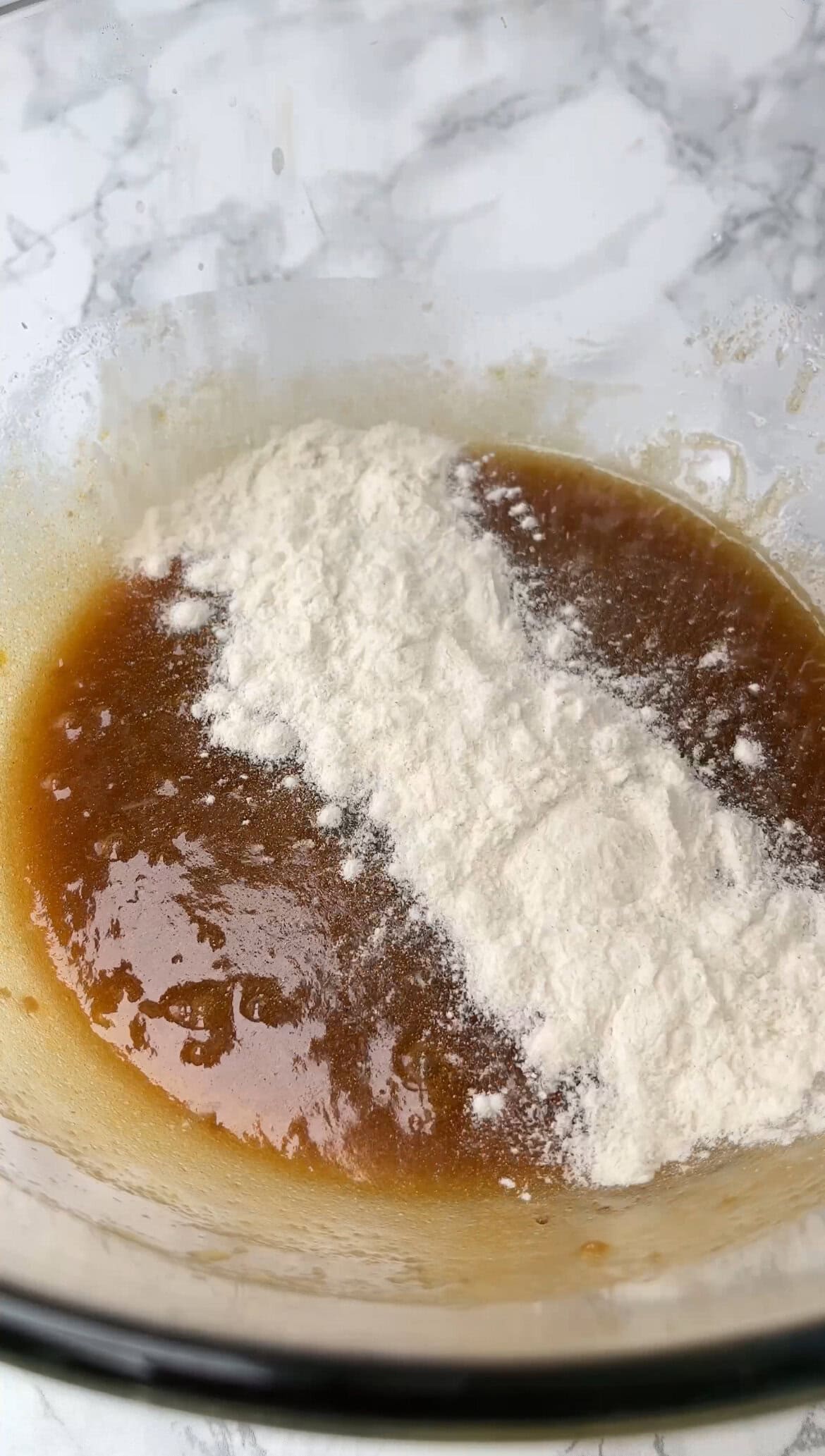 adding flour to the cookie dough.