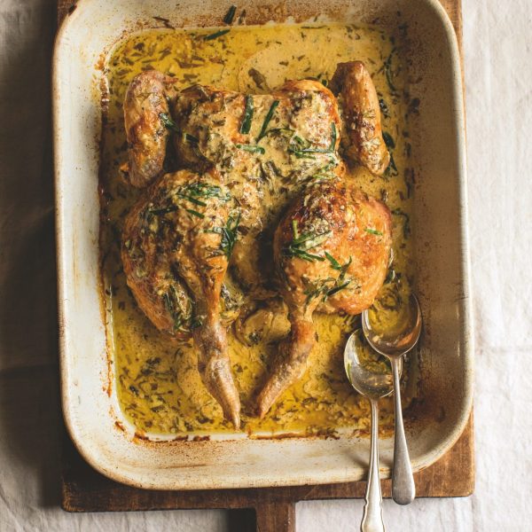 Roast Chicken in a roasting tin with a creamy herby white wine sauce