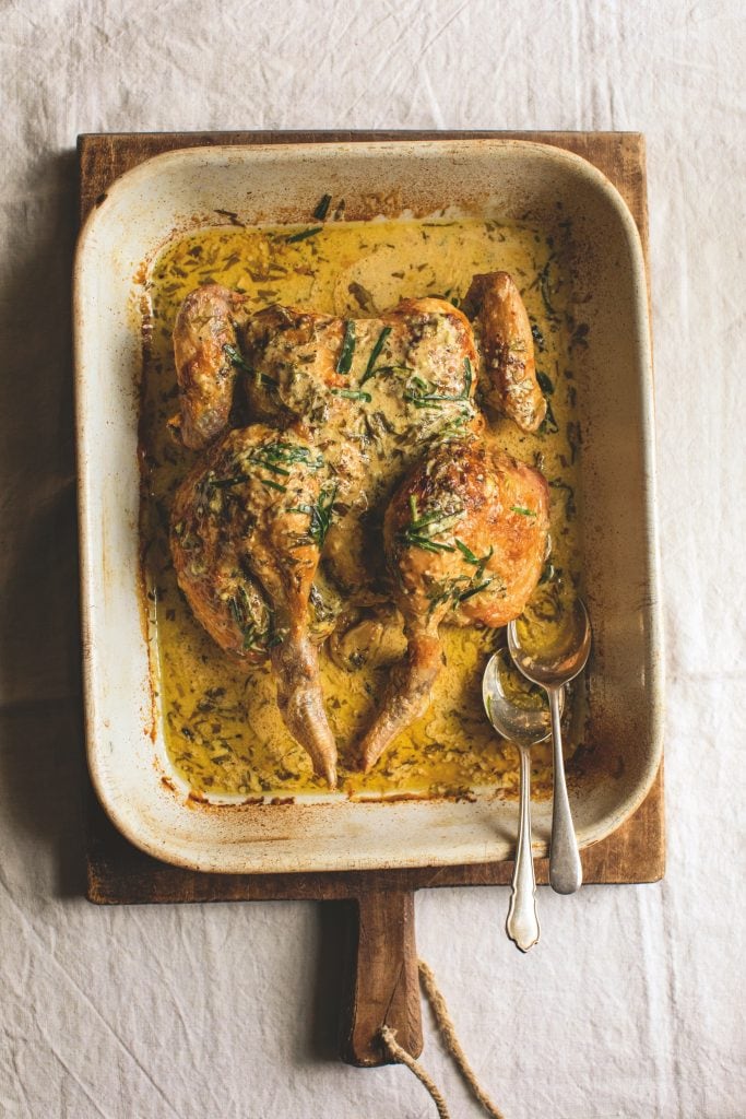 Roast Chicken in a roasting tin with a creamy herby white wine sauce