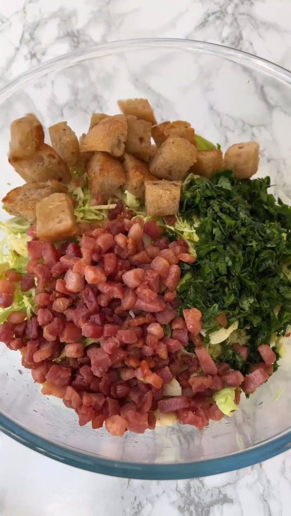 All the ingredients in a bowl for the shaved brussels sprouts salad