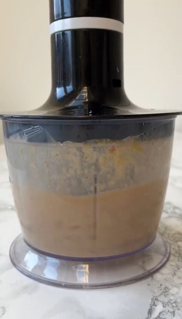 Blender full of creamy caesar salad dressing