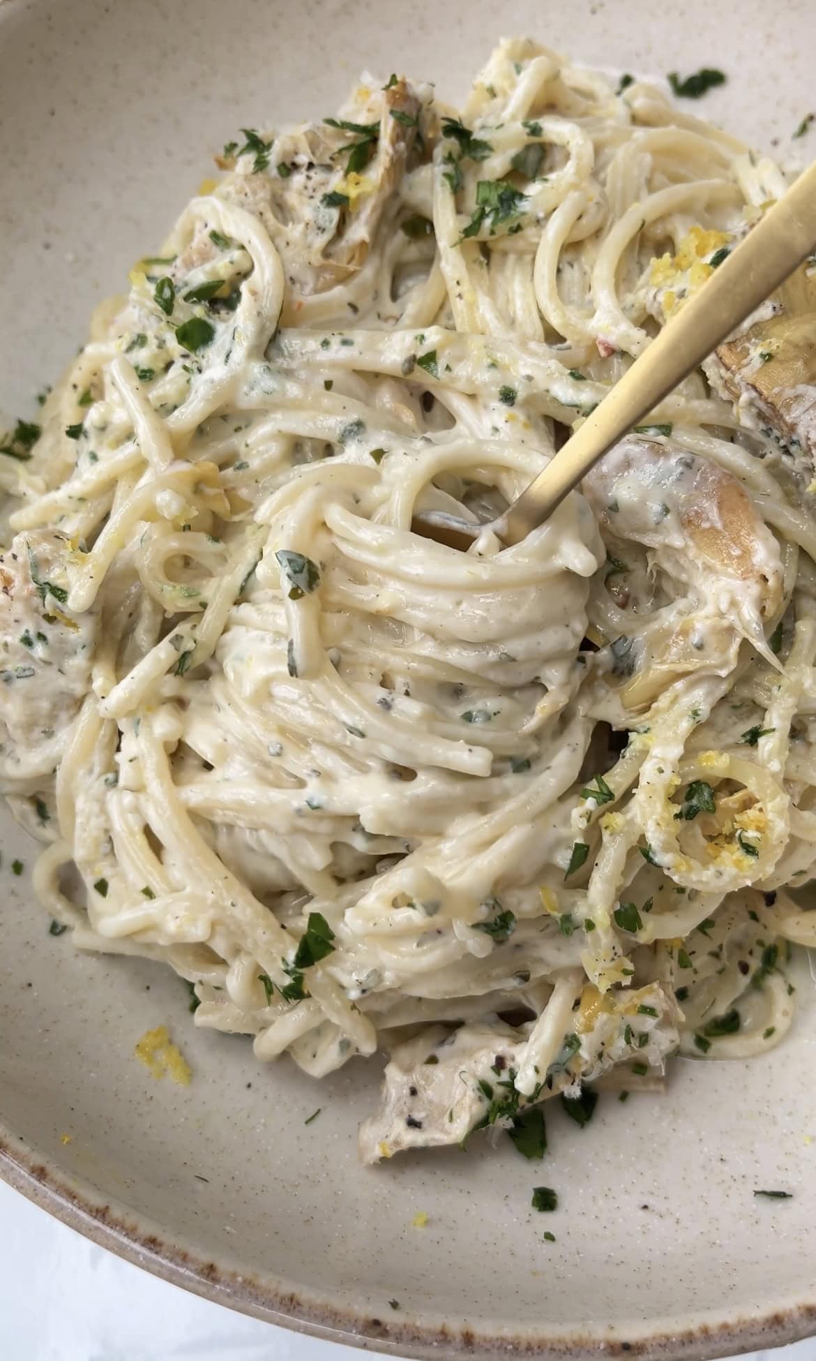 baked boursin pasta with fork twirling.