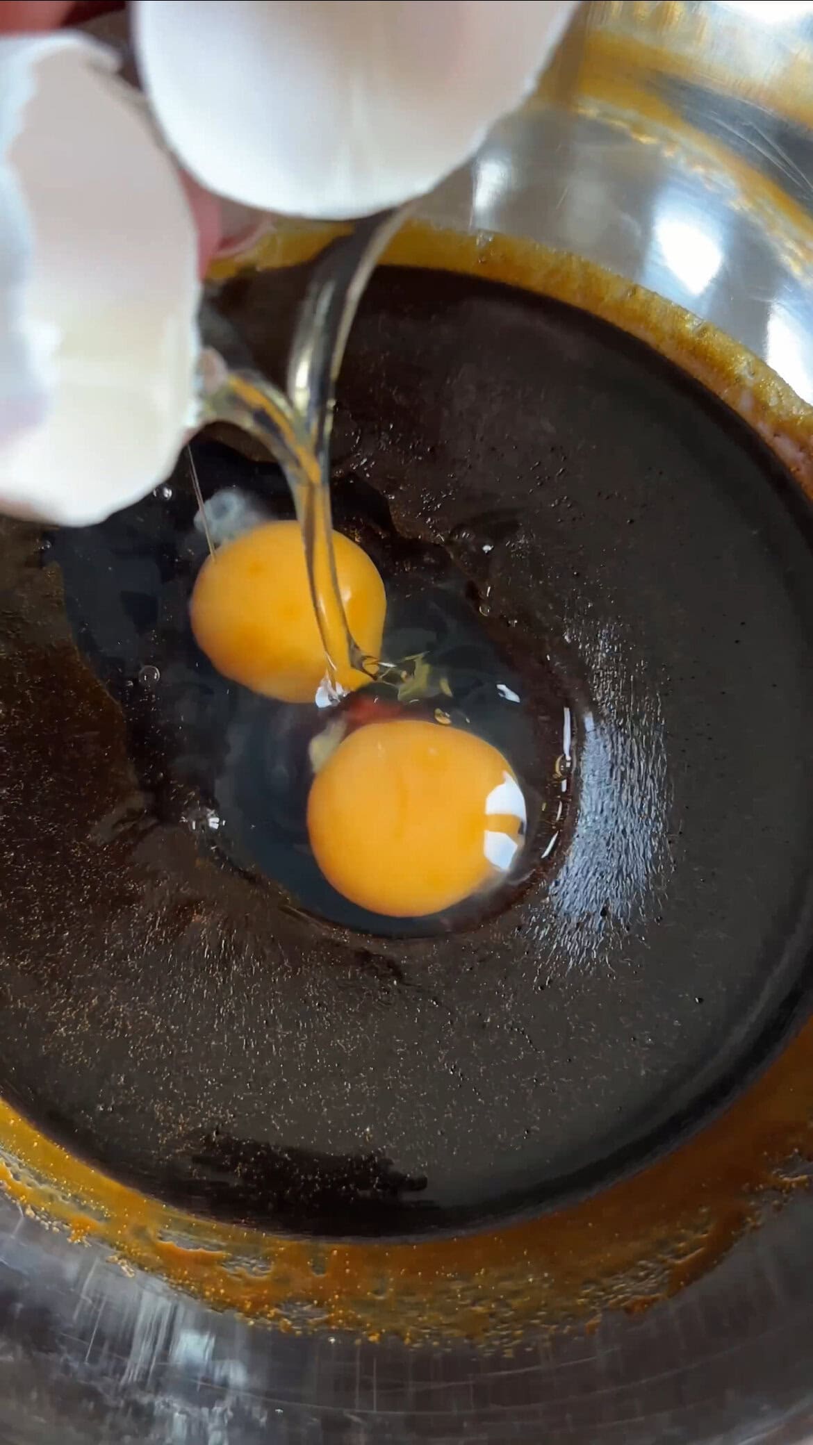 adding eggs to the cake batter.