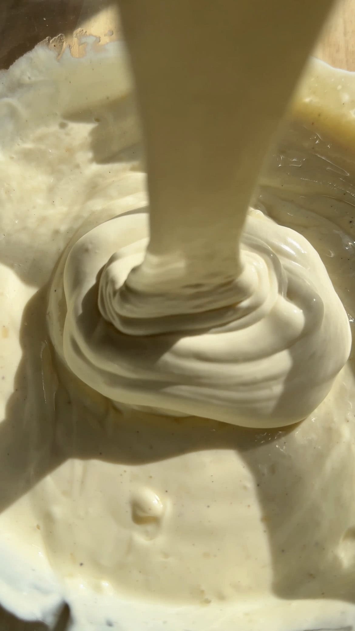 adding whipped cream into cheesecake mix.