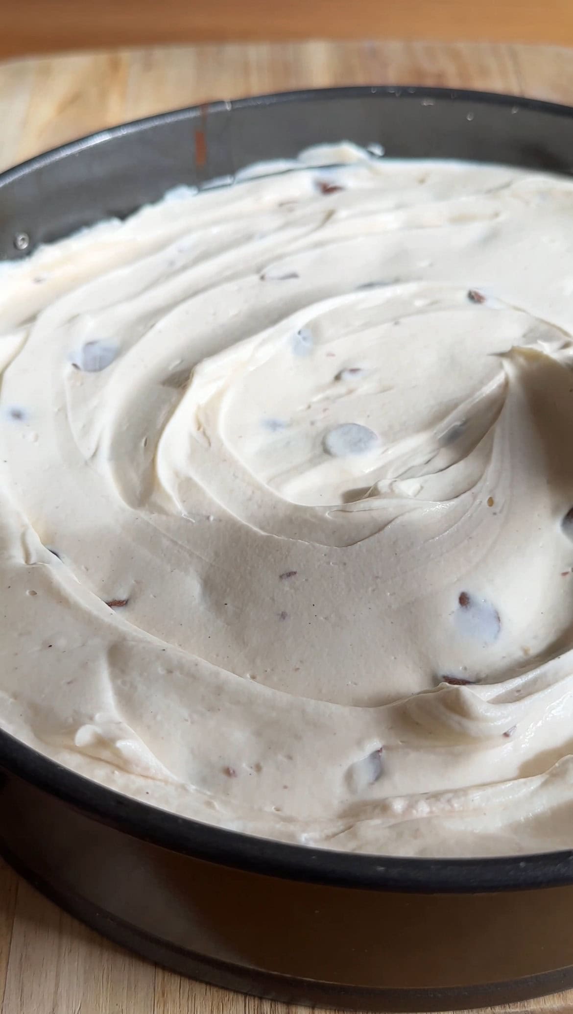 swirling cheesecake filling onto the base.