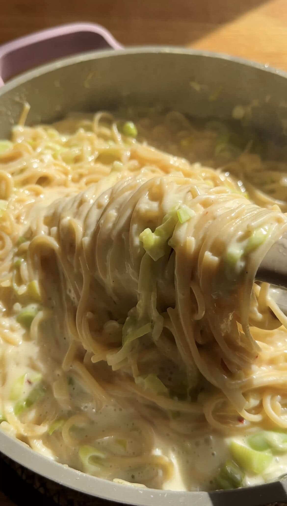 tongs twirling leek pasta