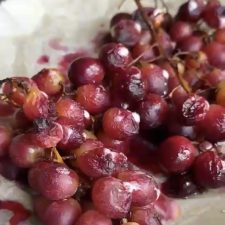 Roasted grapes on a lined baking tray