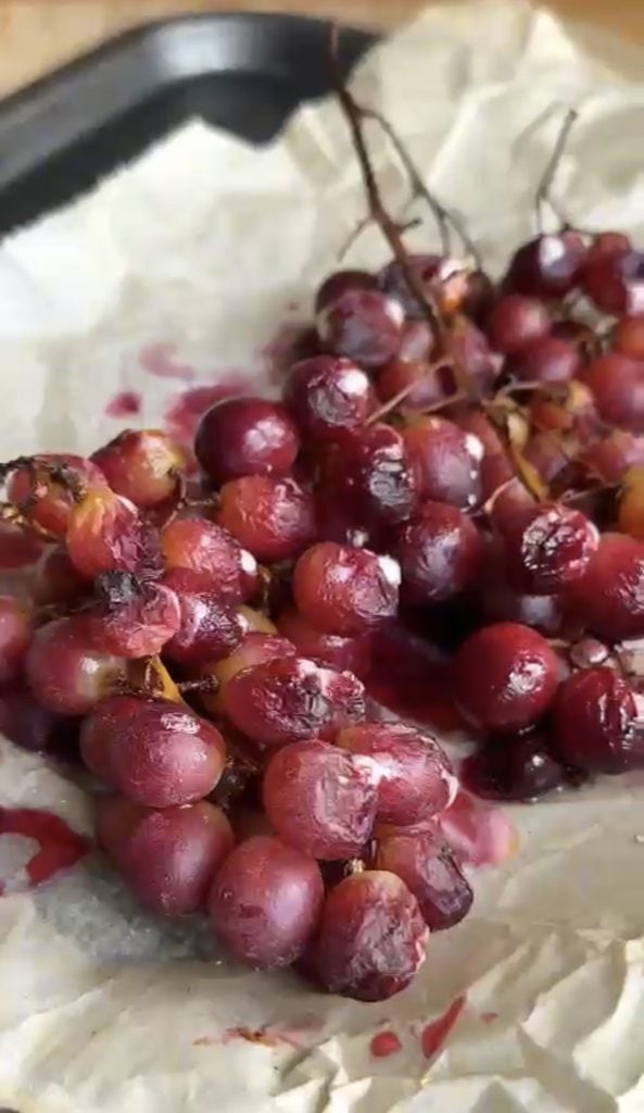 Roasted grapes on a lined baking tray