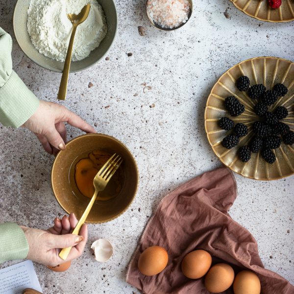 woman whisking eggs with flour and chocolate around