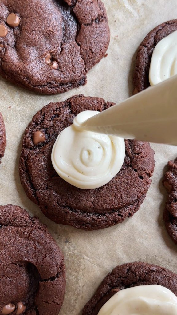 piping bag swirling icing onto tiramisu cookie