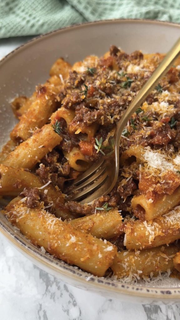 fork in quick bolognese sauce with rigatoni