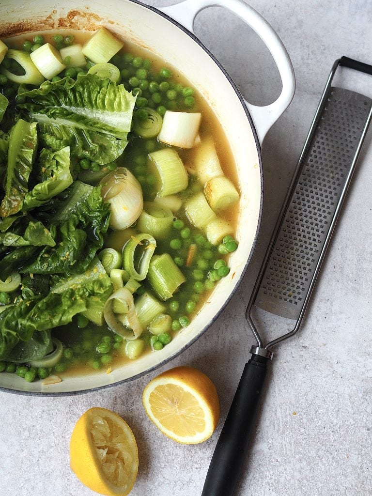 ingredients to make little gem, pea, mint soup in a pan, covered with stock