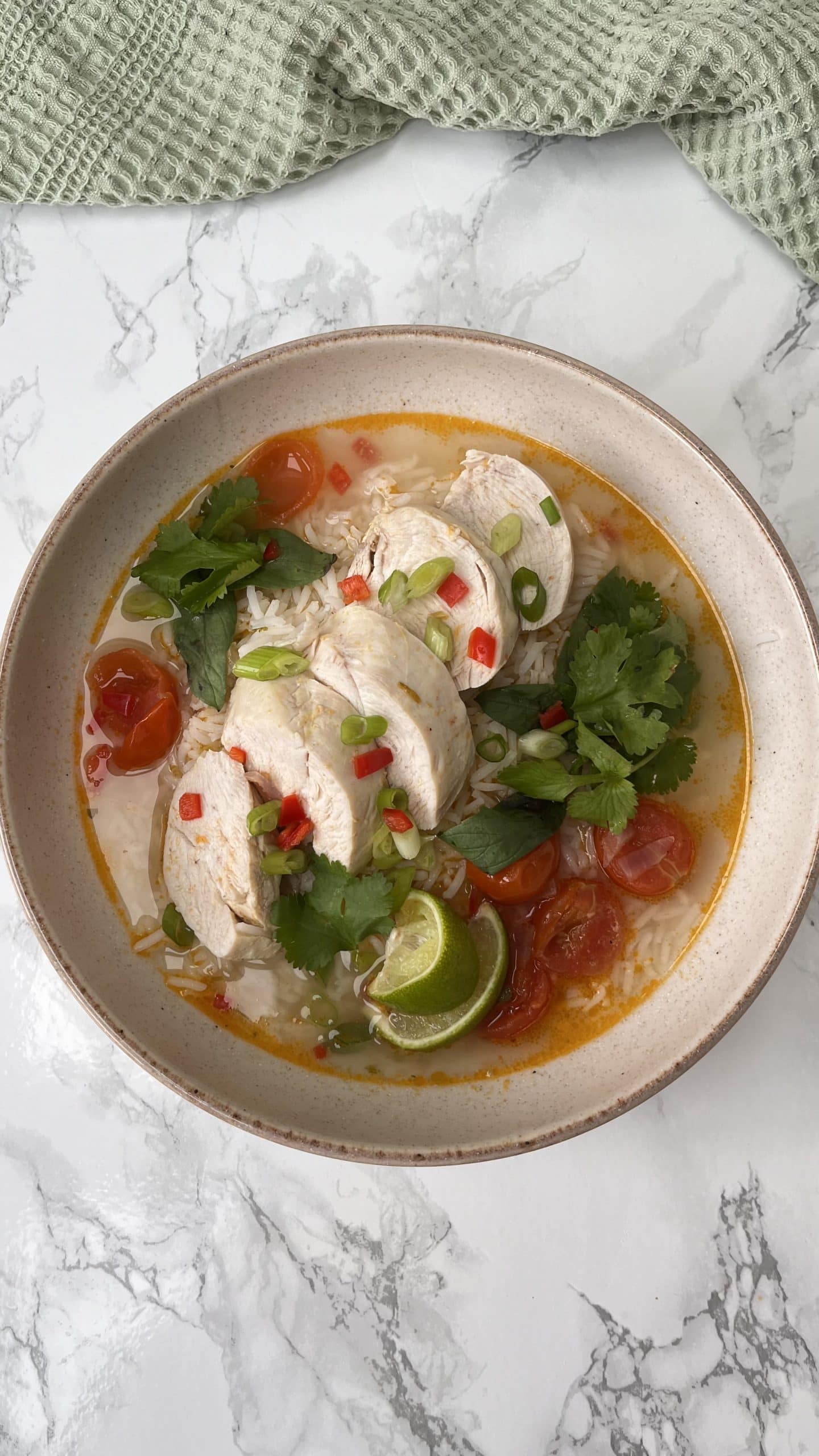 Thai Chicken Soup With Rice in a beige bowl