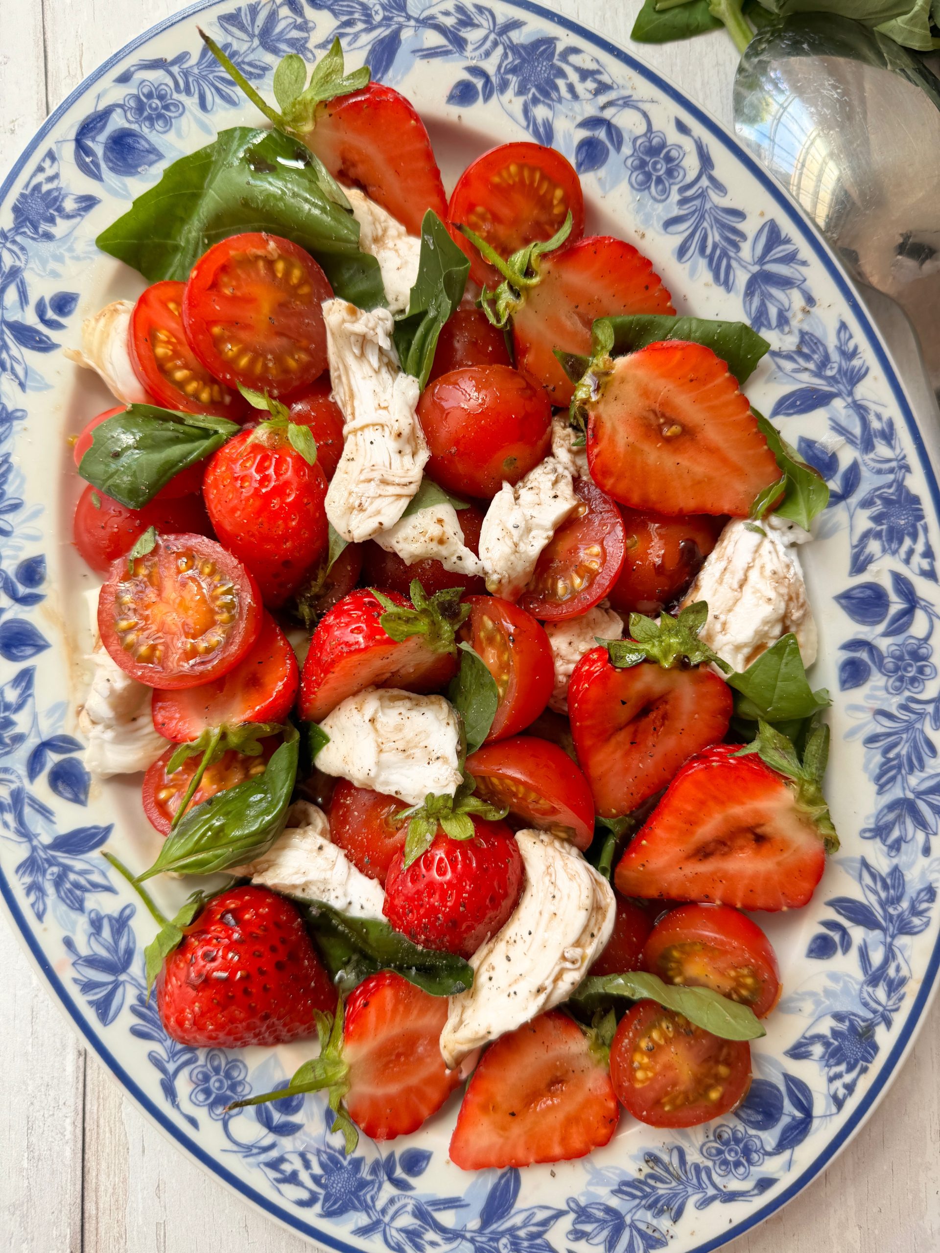 Strawberry and Tomato salad on blue floral plate