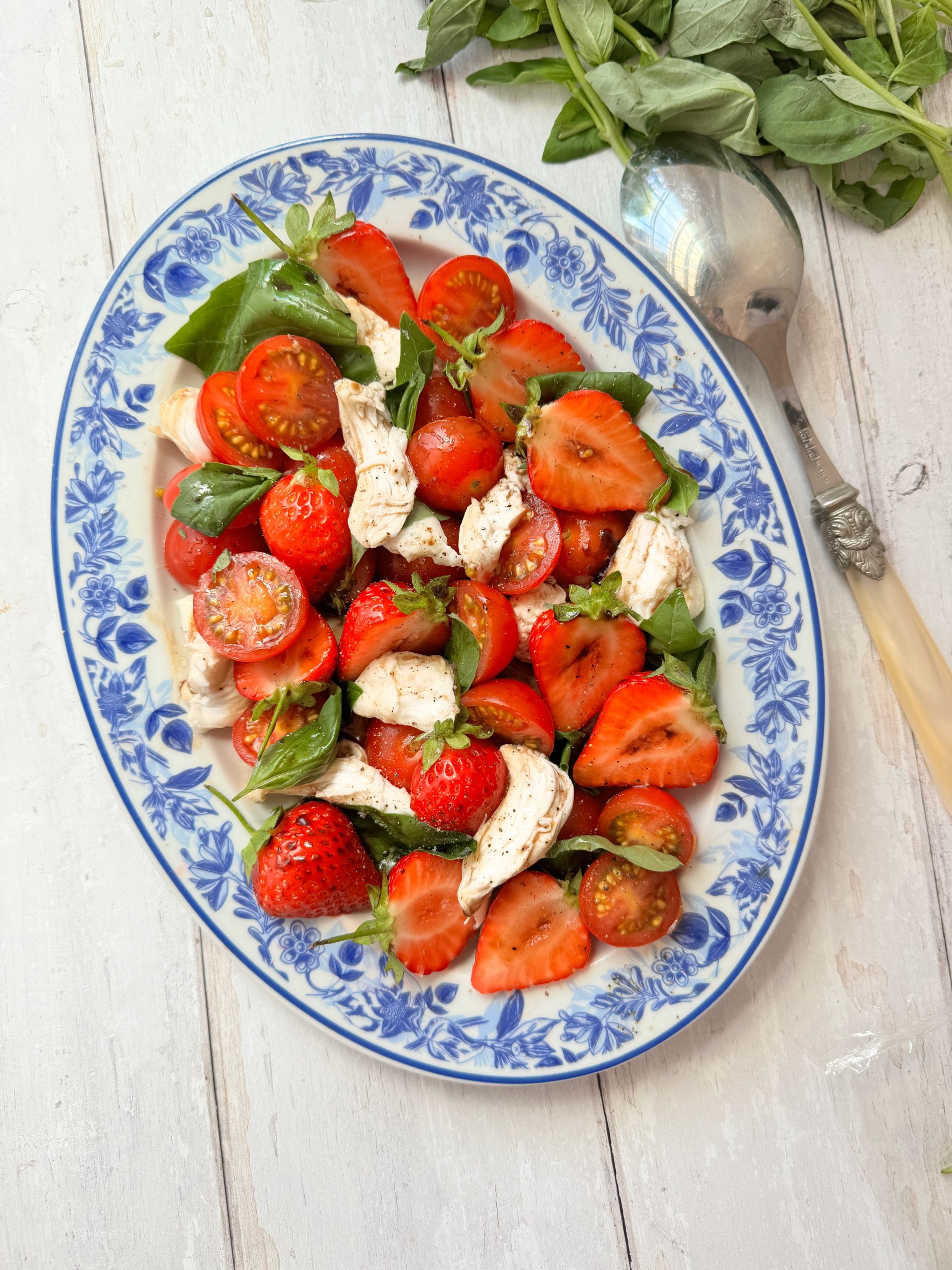 Strawberry and Tomato salad on blue floral plate