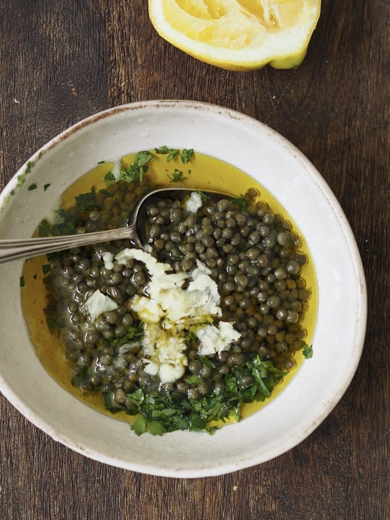 Salsa verde ingredients in a white bowl.