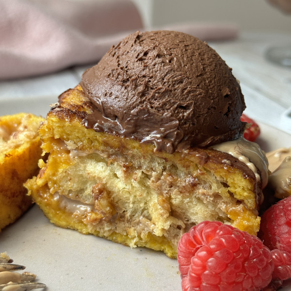 hong kong fnrech toast on a plate with raspberries and chocolate whipped cream