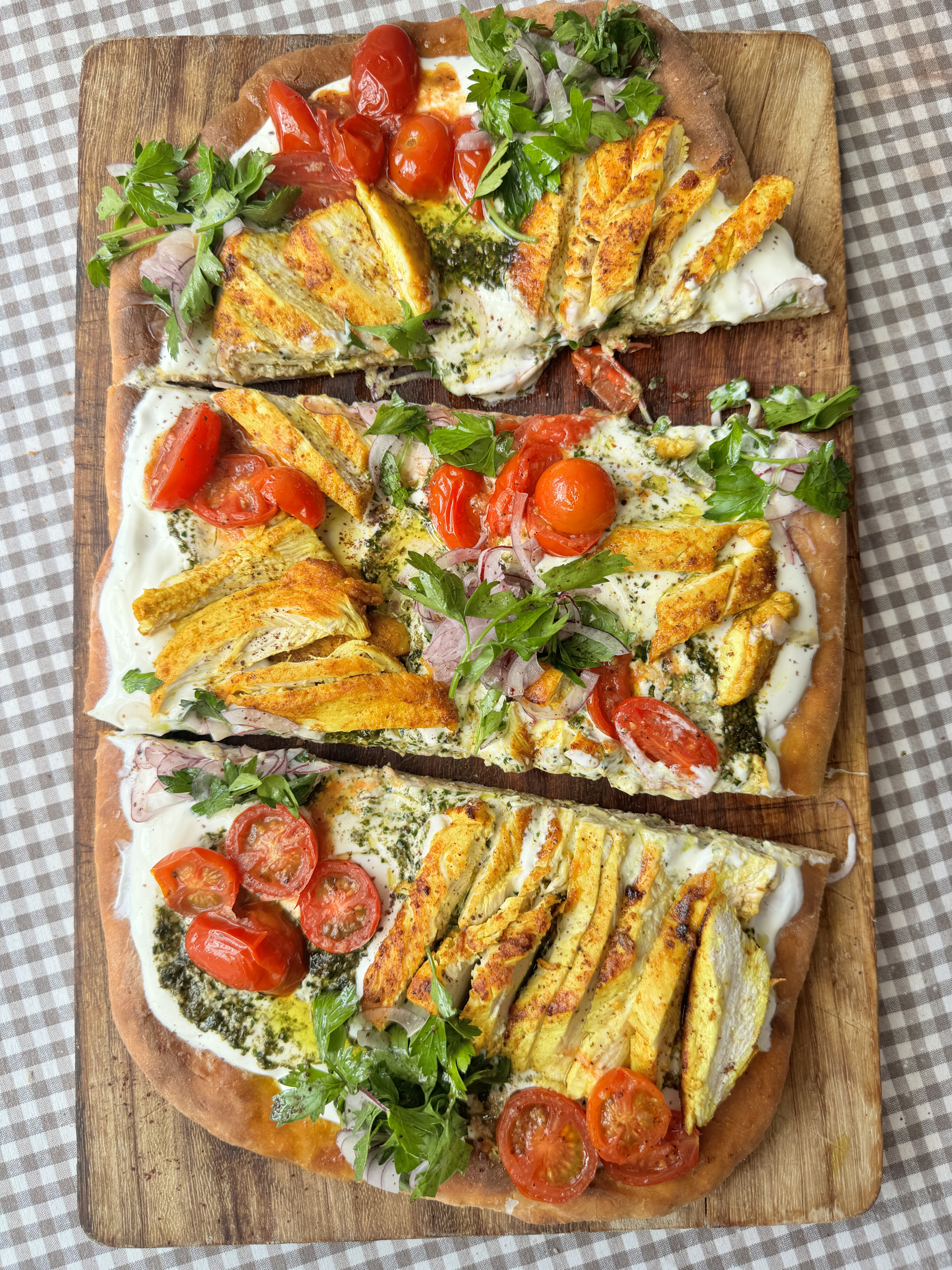 chicken flatbread on wooden board into slices