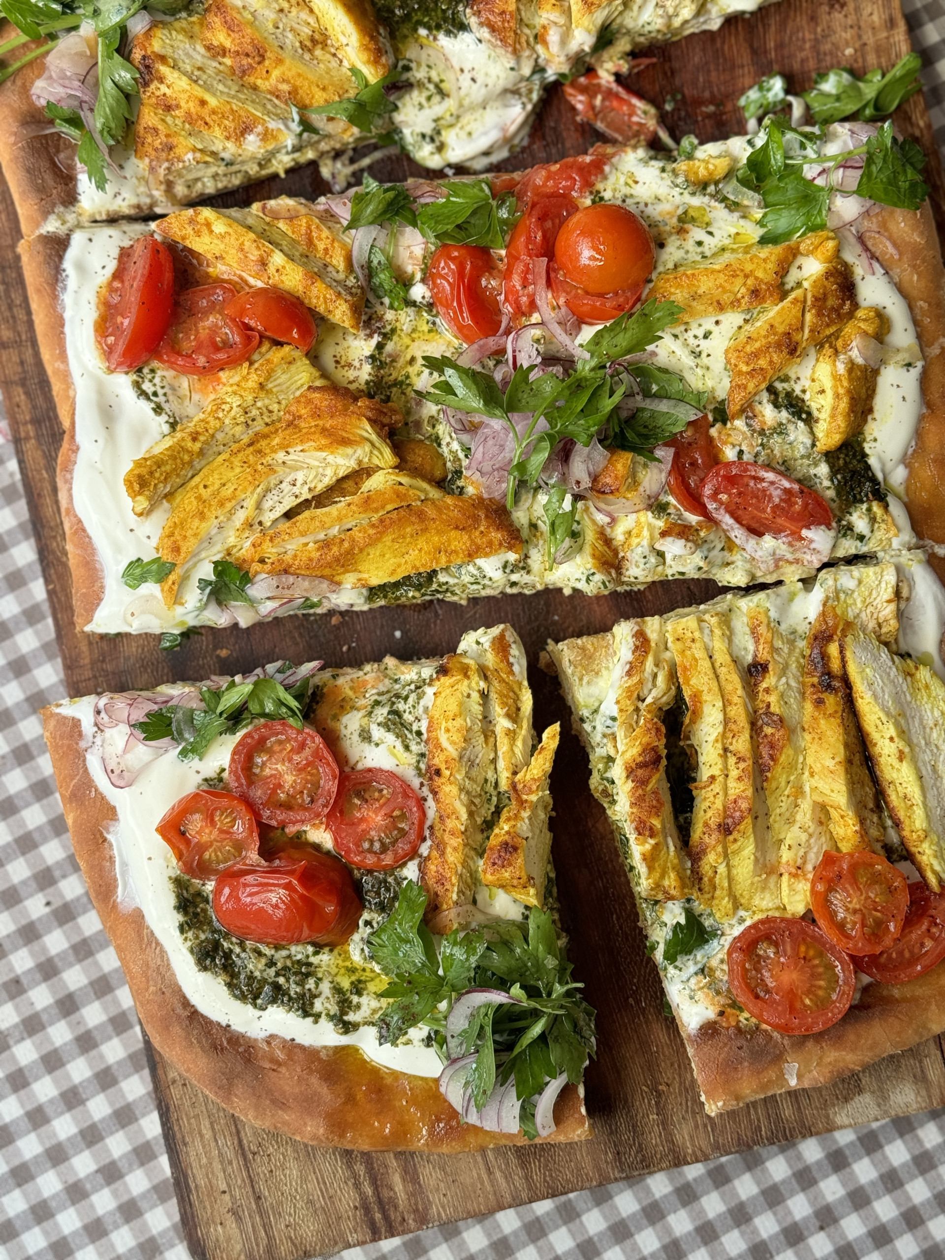 chicken flatbread on wooden board into slices