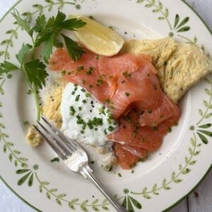 salmon omelette on white plate with fork